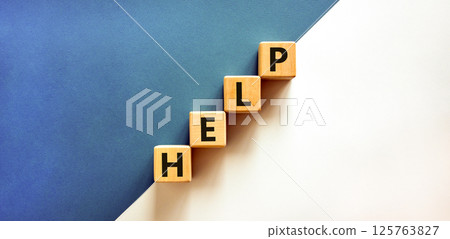 Help symbol. Concept word Help on beautiful wooden blocks. Beautiful white and blue background. Business, lifestyle, support and help concept. Copy space. 125763827