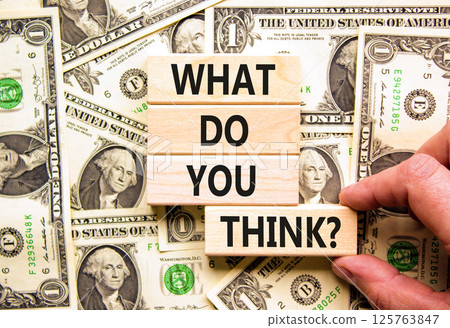 What do you think symbol. Concept words What do you think on beautiful wooden blocks. Dollar bills. Beautiful background from dollar bills. Business and What do you think concept. Copy space. What do you think symbol. Concept words What do you think on beautiful wooden blocks. Dollar bills. Beautiful background from dollar bills. Business and What do you think concept. Copy space. 125763847