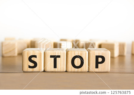 Stop symbol. Concept word Stop on beautiful wooden blocks. Beautiful wooden table white background. Business, lifestyle, support and stop concept. Copy space. 125763875