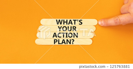 Action plan symbol. Concept words What is your action plan on beautiful wooden sticks. Beautiful orange table orange background. Businessman hand. Business What is your action plan concept. Copy space Action plan symbol. Concept words What is your action plan on beautiful wooden sticks. Beautiful orange table orange background. Businessman hand. Business What is your action plan concept. Copy space 125763881