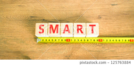 Smart symbol. Concept word Smart on beautiful wooden blocks. Beautiful wooden table wooden background. Beautiful yellow ruler. Business lifestyle smart concept. Copy space. 125763884