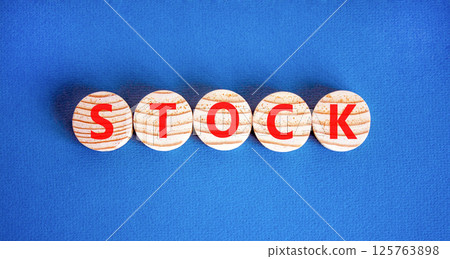 Stock symbol. Concept word Stock on beautiful wooden circles. Beautiful blue table blue background. Business lifestyle stock concept. Copy space. 125763898
