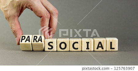 Social or parasocial symbol. Concept words Social or Parasocial on beautiful wooden blocks. Beautiful grey table grey background. Businessman hand. Business social parasocial concept. Copy space. 125763907
