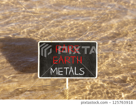 Rare earth metals symbol. Concept words Rare earth metals on beautiful blackboard. Beautiful Red sea water background. Business and rare earth metals concept. Copy space. 125763918