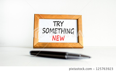 Try something new symbol. Concept words Try something new on beautiful wooden picture frame. Beautiful white background. Business motivational lifestyle try something new concept. Copy space. Try something new symbol. Concept words Try something new on beautiful wooden picture frame. Beautiful white background. Business motivational lifestyle try something new concept. Copy space. 125763923