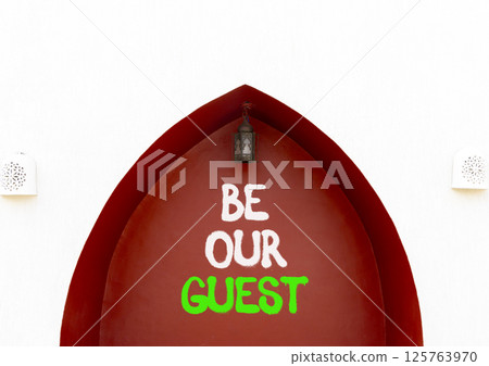 Be our guest symbol. Concept words Be our guest on beautiful white and red wall. Beautiful white and red wall background. Business and be our guest concept. Copy space. Be our guest symbol. Concept words Be our guest on beautiful white and red wall. Beautiful white and red wall background. Business and be our guest concept. Copy space. 125763970