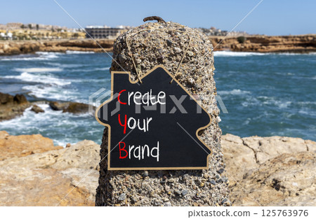 CYB Create your brand symbol. Concept words CYB Create your brand on beautiful yellow blackboard. Beautiful stone blue sky sea background. Business CYB Create your brand concept. Copy space. CYB Create your brand symbol. Concept words CYB Create your brand on beautiful yellow blackboard. Beautiful stone blue sky sea background. Business CYB Create your brand concept. Copy space. 125763976