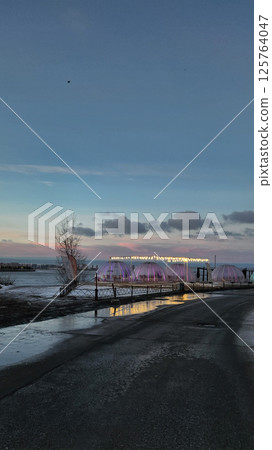 Fantastic winter landscape at dawn. Beautiful natural landscape of ice park with shining sunlight with reflections on ice. Saint Petersburg, Russia. Vertical photo. High quality photo 125764047