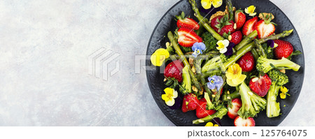 A refreshing asparagus salad with strawberries. 125764075