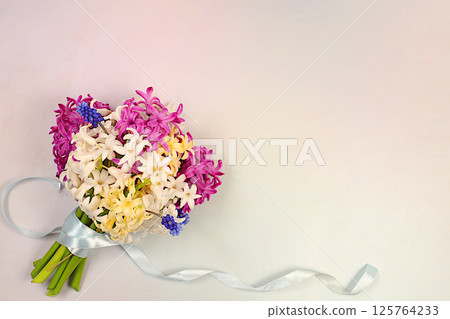 Beautiful bouquet of different varieties of hyacinths and muscari. Abstract flower arrangement for screen and design template. Spring card, business card for product display, gift for loved ones. 125764233