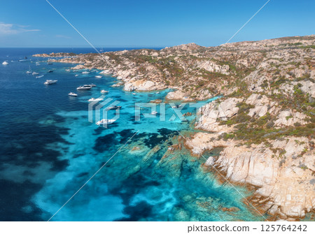 Aerial view capturing luxury yachts moored along the coastline 125764242