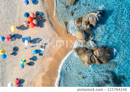 Aerial view of colorful umbrellas, sandy beach and blue sea 125764248