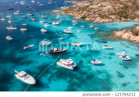 Aerial view of luxury yachts and boats in blue sea in summer Aerial view of luxury yachts and boats in blue sea in summer 125764252