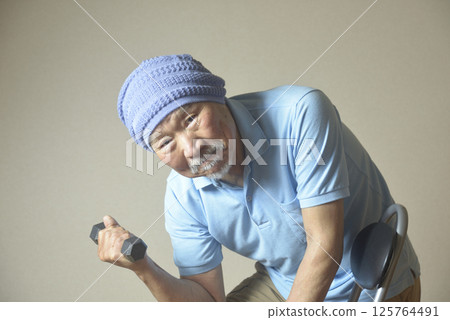 Bearded old man doing muscle training with dumbbells Bearded old man doing muscle training with dumbbells 125764491