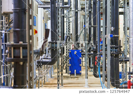 Detailed Interior View of a Complex Industrial Piping and Plumbing System 125764947