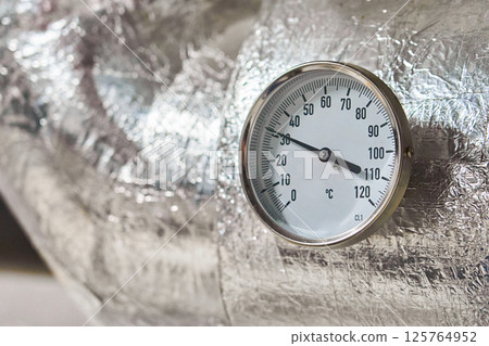 Industrial Pressure Gauge with Metal Housings and Insulation Displaying Measurements in Bar on a Piping Industrial Pressure Gauge with Metal Housings and Insulation Displaying Measurements in Bar on a Piping 125764952