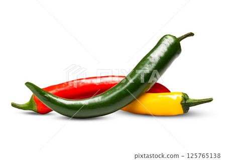 Three multi-colored hot chili peppers on a white background close-up Three multi-colored hot chili peppers on a white background close-up 125765138