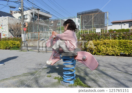 Girls playing with park play equipment Girls playing with park play equipment 125765151
