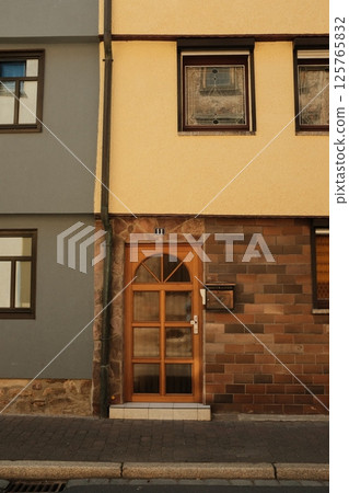 colorful traditional european house facades and wooden framed windows with vintage design and textured walls. High quality photo colorful traditional european house facades and wooden framed windows with vintage design and textured walls. High quality photo 125765832