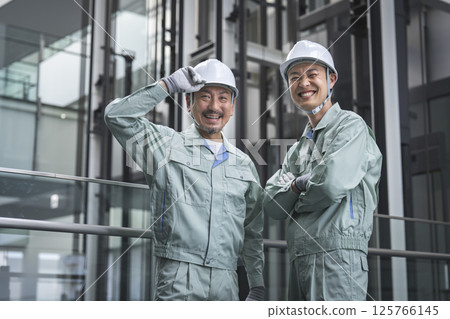 Two workers looking at the camera Two workers looking at the camera 125766145