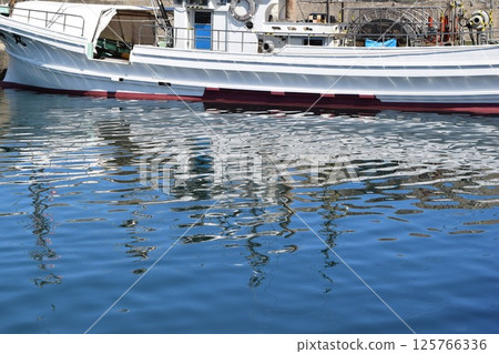 Fishing boat anchored at the fishing port 125766336