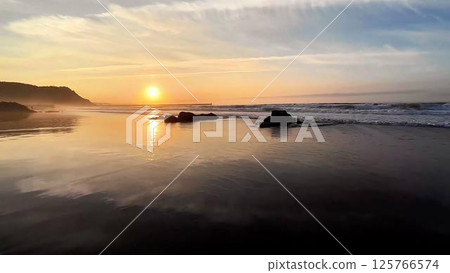 Witness the breathtaking beauty of a stunning sunset at the tranquil, serene beachside 125766574