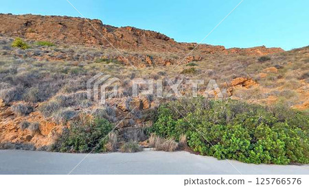 A stunning and serene cliffside beach landscape that captivates the beauty of nature 125766576