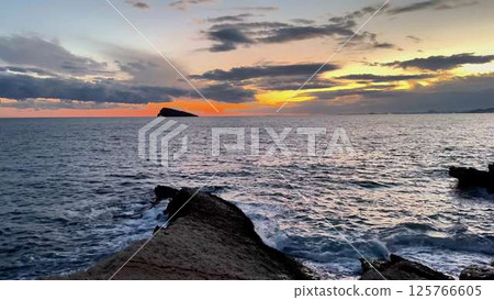Incredible and Stunning Sunset Over the Ocean with Beautiful Dramatic Clouds in the Sky Incredible and Stunning Sunset Over the Ocean with Beautiful Dramatic Clouds in the Sky 125766605