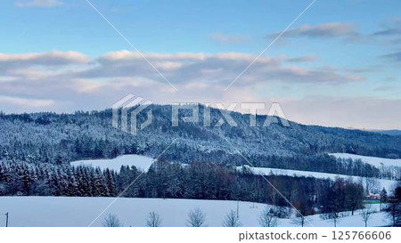 A Serene Winter Landscape Featuring Beautiful, SnowCapped Hills Against Clear Blue Skies A Serene Winter Landscape Featuring Beautiful, SnowCapped Hills Against Clear Blue Skies 125766606