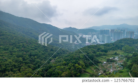 May 1 2021 Urban Landscape Surrounded by Lush Green Forested Hills May 1 2021 Urban Landscape Surrounded by Lush Green Forested Hills 125766702