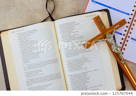24 April 2025 Washington DC US Open Holy Bible lays open with highlighted verses next to wooden crucifix, planner, illustrating moment of reflection. 24 April 2025 Washington DC US Open Holy Bible lays open with highlighted verses next to wooden crucifix, planner, illustrating moment of reflection. 125767044