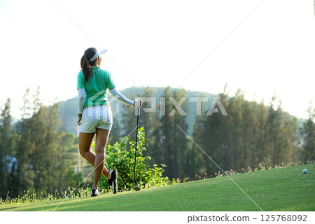 Golfer sport course golf ball fairway. People lifestyle woman relax after swing golf ball  125768092