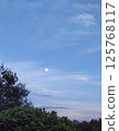 The moon floating in the eastern sky 125768117