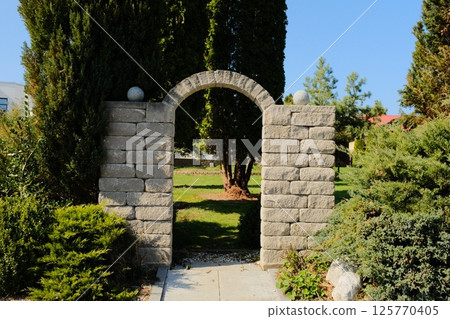 european village garden decorated with white easter bunny statues and spring greenery under clear sky. High quality photo european village garden decorated with white easter bunny statues and spring greenery under clear sky. High quality photo 125770405
