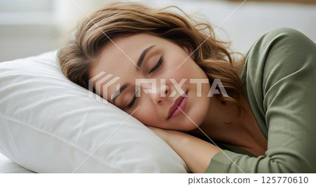 Woman sleeping peacefully in bed Woman sleeping peacefully in bed 125770610