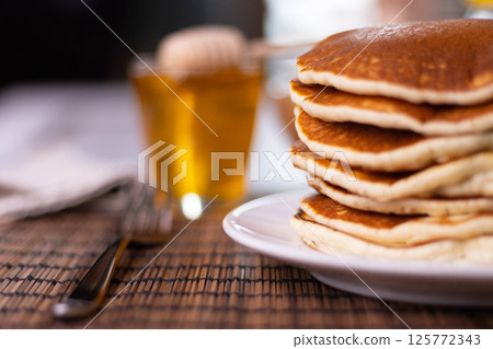Pancake breakfast with honey and granola Pancake breakfast with honey and granola 125772343