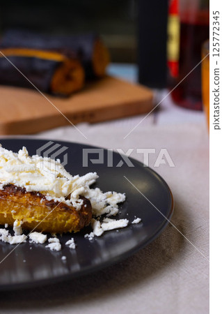 Baked plantains with white cheese Baked plantains with white cheese 125772345