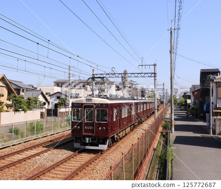 Hankyu Itami Line 6000 series train running near Inano Station Hankyu Itami Line 6000 series train running near Inano Station 125772687
