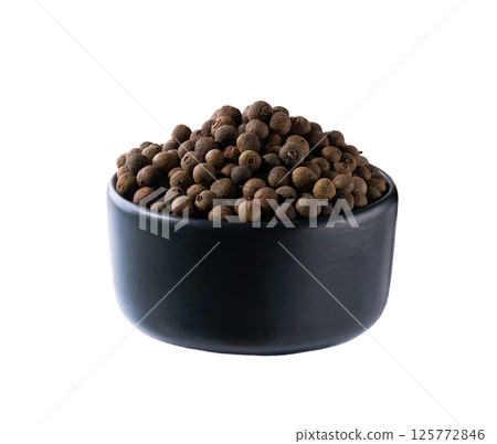 black ceramic bowl with allspice or Jamaican pepper isolated on white background. black ceramic bowl with allspice or Jamaican pepper isolated on white background. 125772846