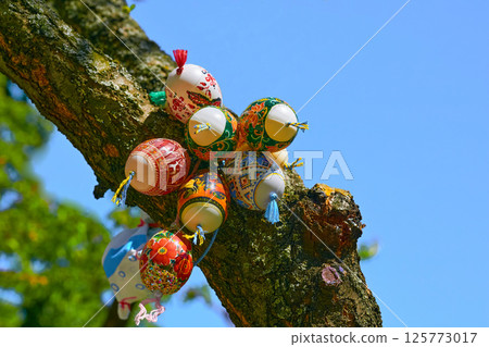 Bright colored spring bouquet of painted Easter eggs on green tree Bright colored spring bouquet of painted Easter eggs on green tree 125773017