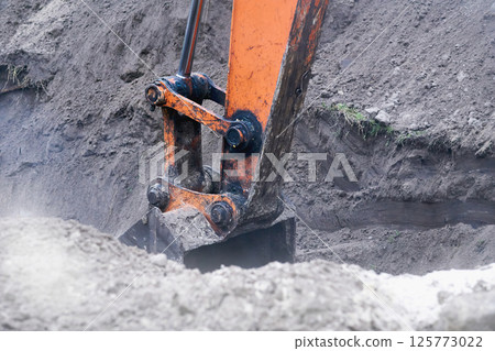 Excavator bulldozer bucket digging a hole, trench.Loading bulk 125773022