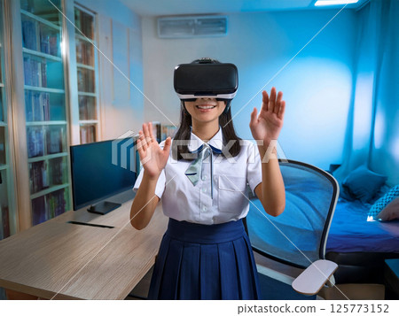 A female junior high school student wearing a head-mounted display 125773152