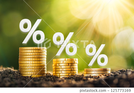 Mortgage rates A pile of coins placed on the table together with interest rate illustrations. planning savings money of coins to buy a home concept for property, mortgage, real estate. 125773169