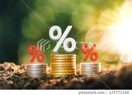 Mortgage rates A pile of coins placed on the table together with interest rate illustrations. planning savings money of coins to buy a home concept for property, mortgage, real estate. 125773184