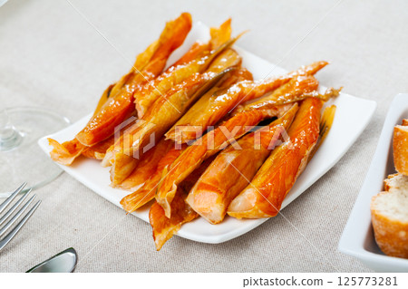 Cold smoked salmon belly strips 125773281