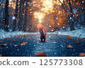 Rear view of a squirrel walking along a road in a snowy forest 125773308