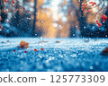 Winter scenery of a snowy forest path, fallen leaves and snowberries 125773309