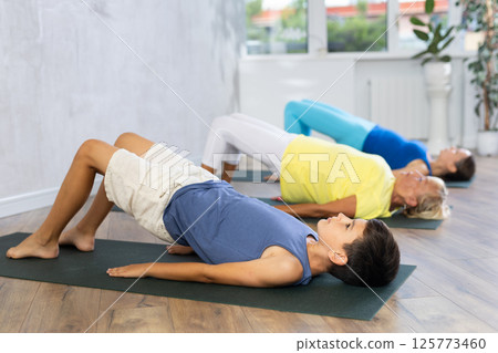 Family generation doing Half bridge pose. Family generation doing Half bridge pose. 125773460