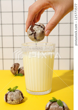 Appetizing Grinkle cookies with milk, on a yellow background. Appetizing Grinkle cookies with milk, on a yellow background. 125773577