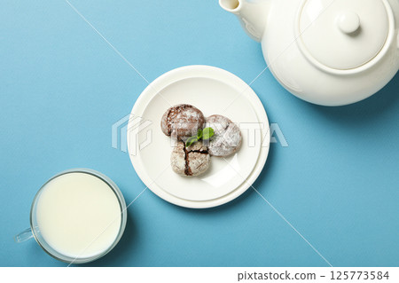 Appetizing crinkle cookies, on a blue background. Appetizing crinkle cookies, on a blue background. 125773584